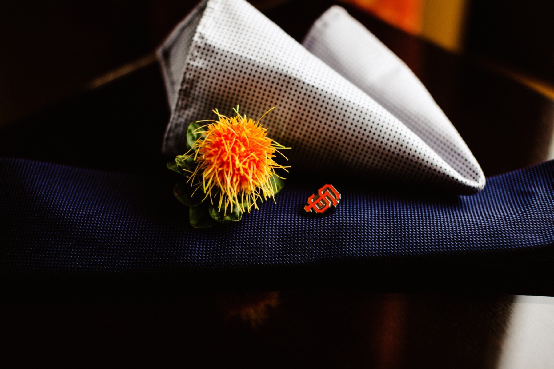 orange flower with san francisco pin and pocket square