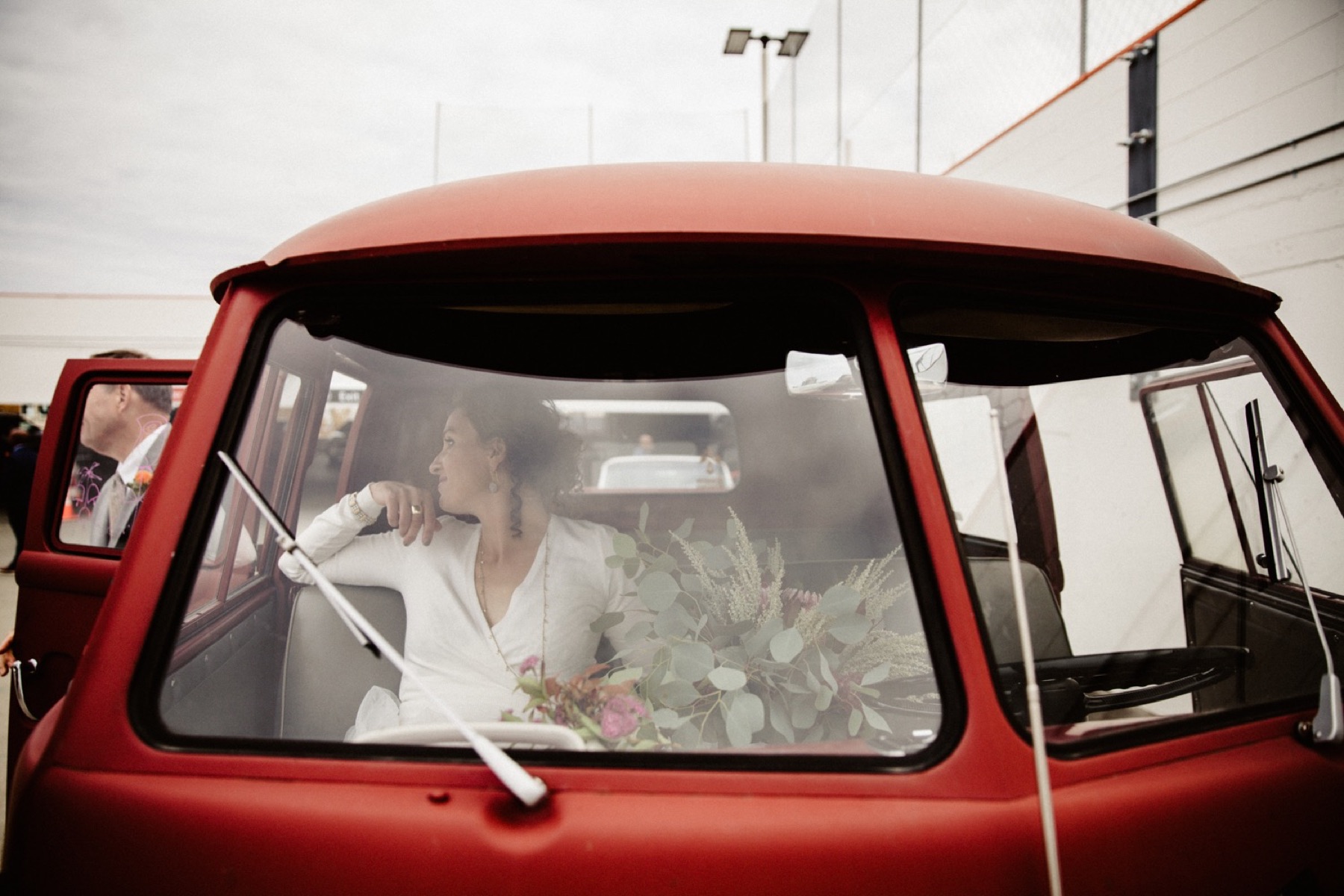 bride waits in vintage VW bus to go to wedding ceremony