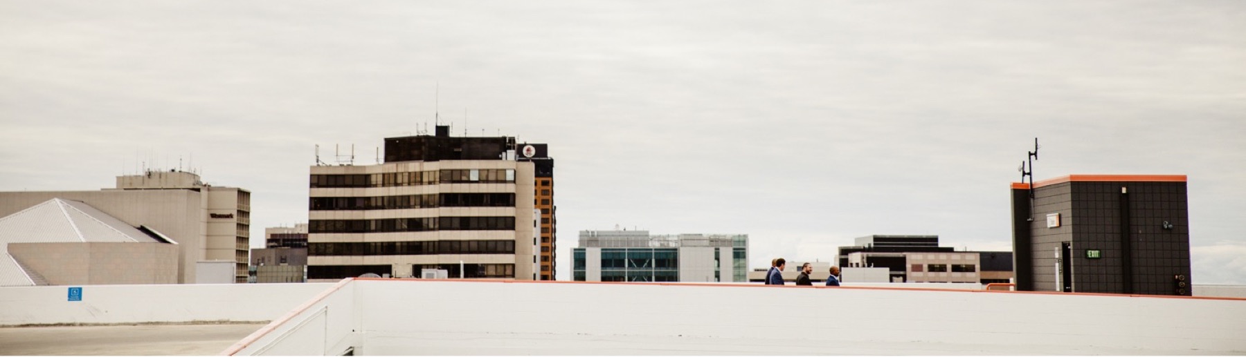 bridal party walks to wedding ceremony on easy park garage rooftop in anchorage