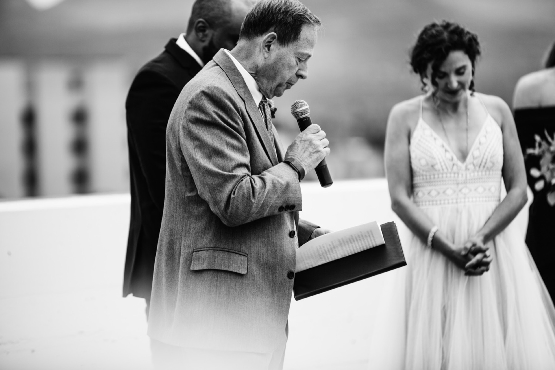 bride's dad prays during wedding ceremony