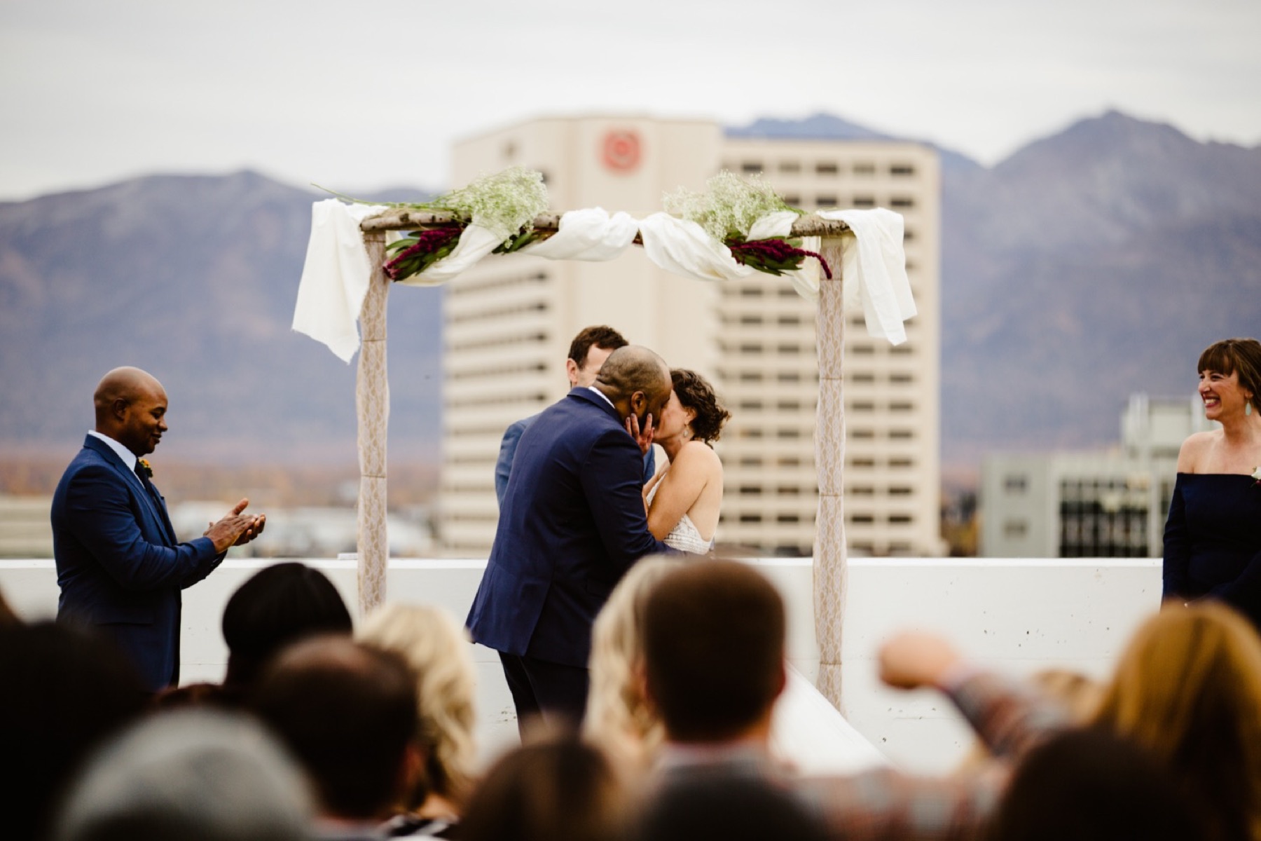 bride and groom exchange first kiss on rooftop of easy park garage in downtown anchorage