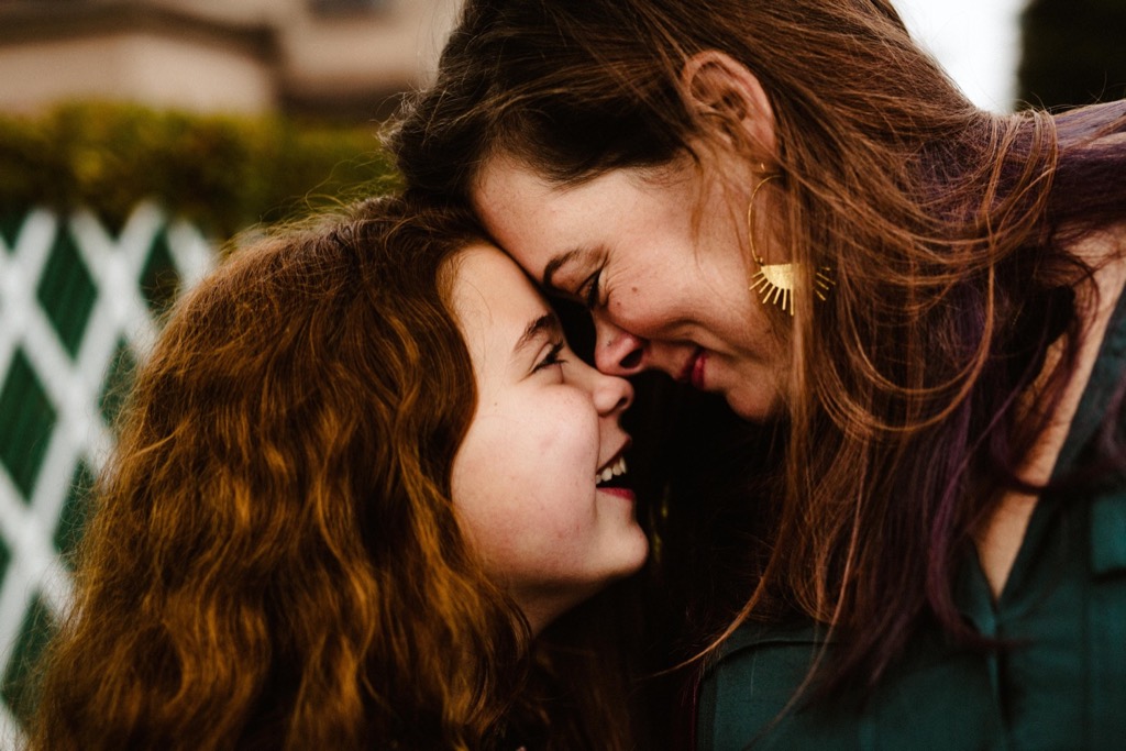 mother and daughter press noses together 