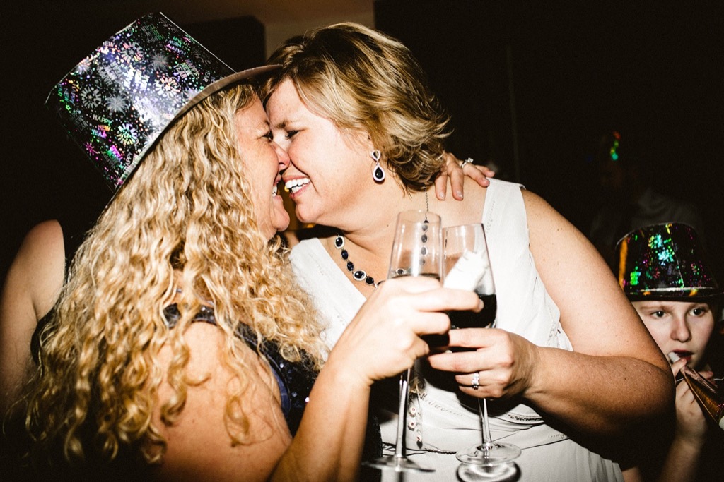 bride and bride toast champagne at midnight of new year's eve wedding
