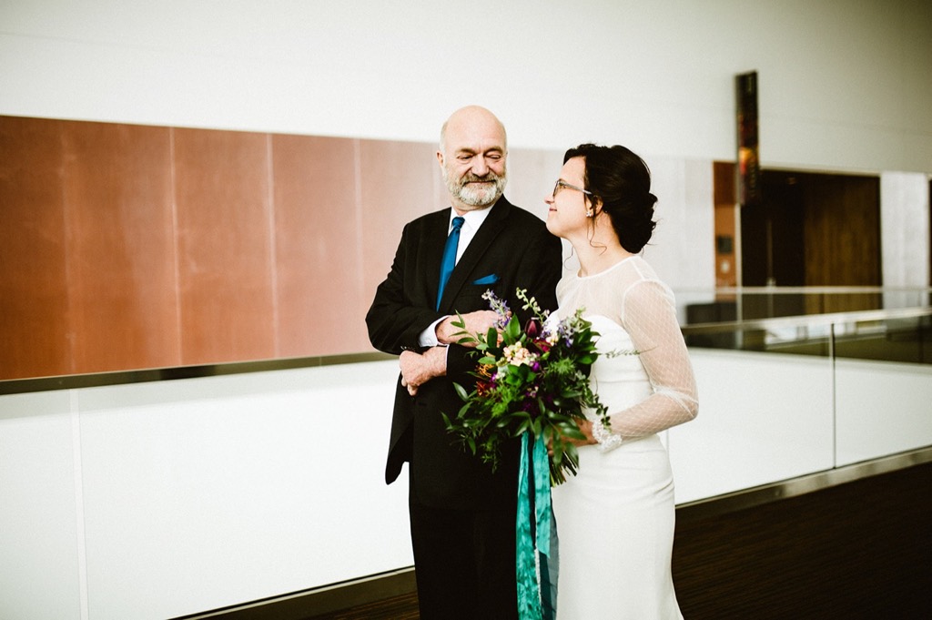 father and bride share an emotional glance at denaina center wedding 