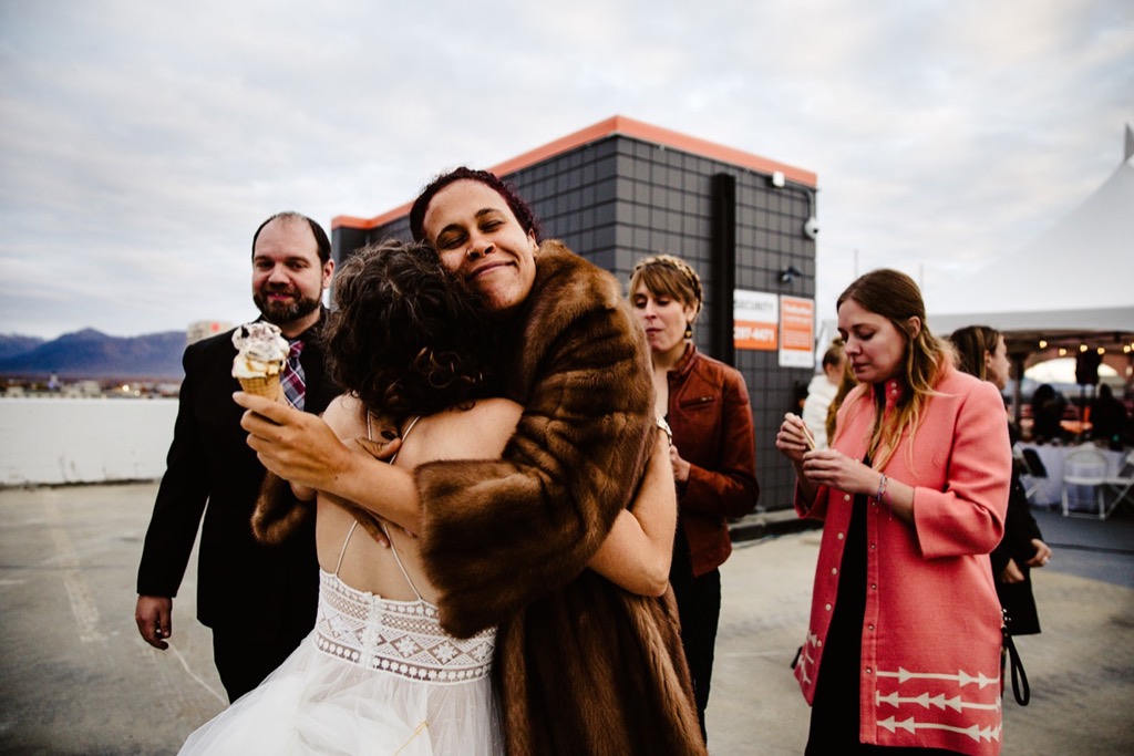 friends embrace in downtown anchorage wedding 