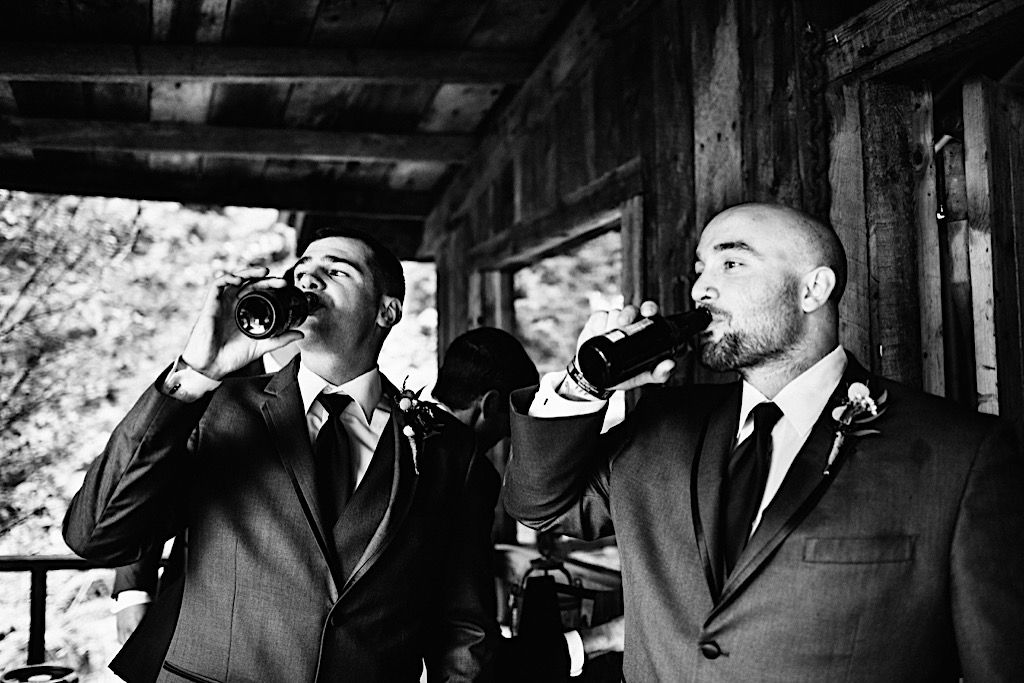 groom shares a beer with groomsman