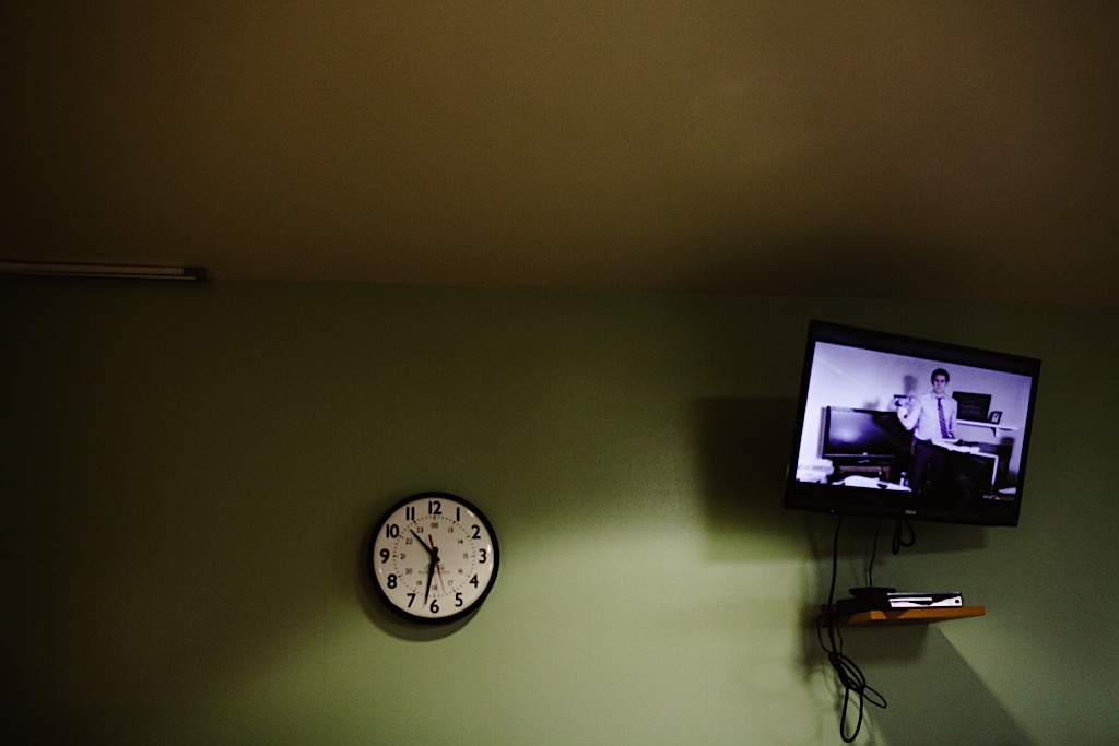 the office on tv and a clock on the wall 