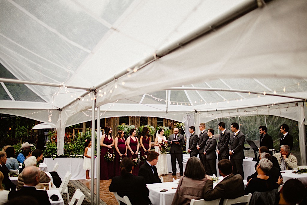 wedding ceremony under clear tent at crow creek mine