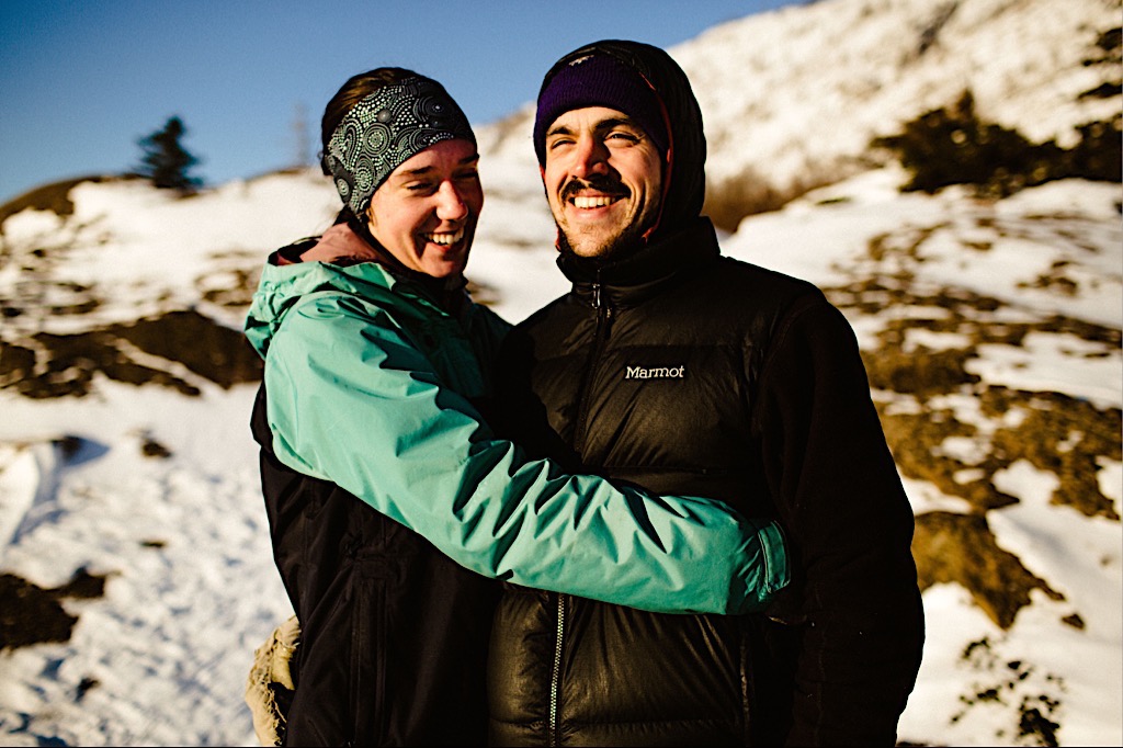 couple in outdoor gear laughing 