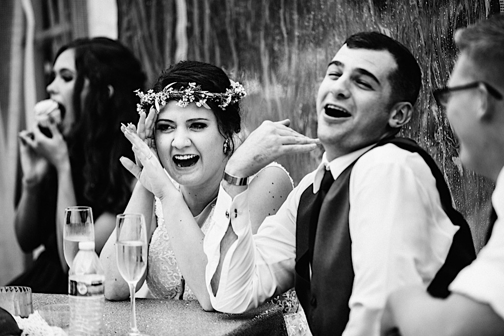 couple laughing at wedding toast 