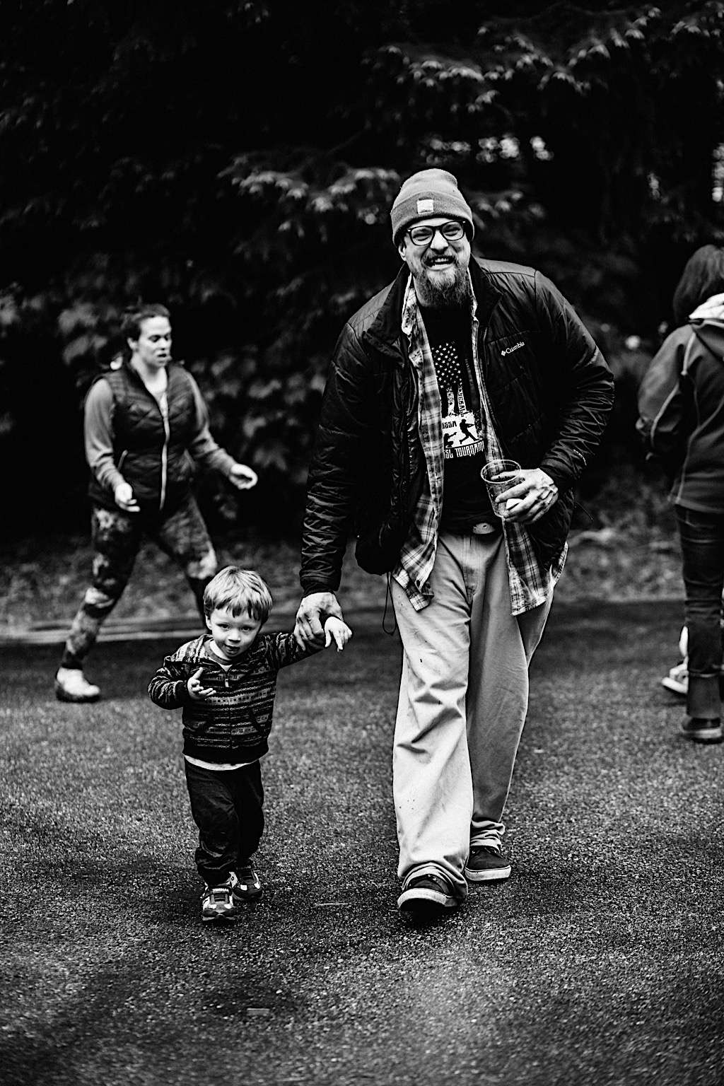 father holding hands walking with young son