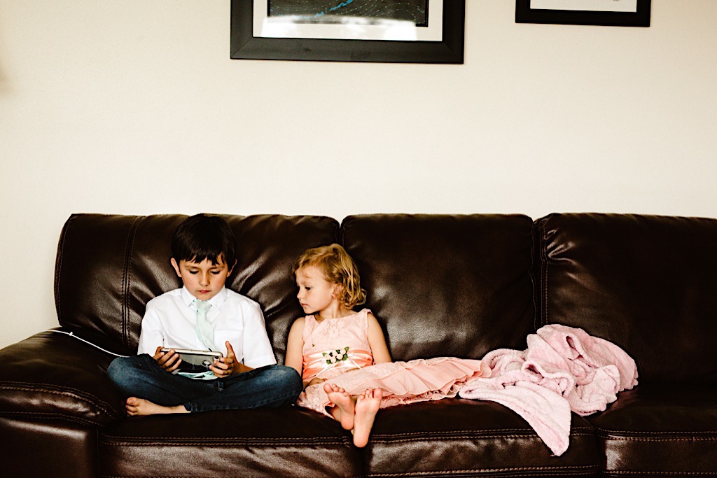 small children on couch playing a game 