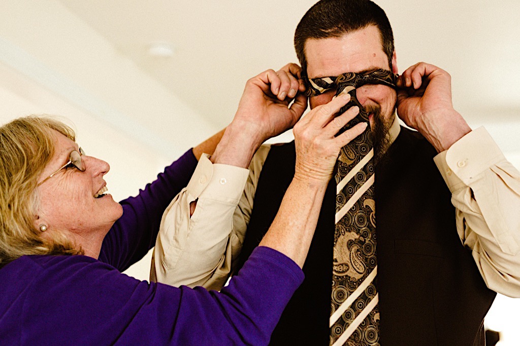 mom helps son put on tie