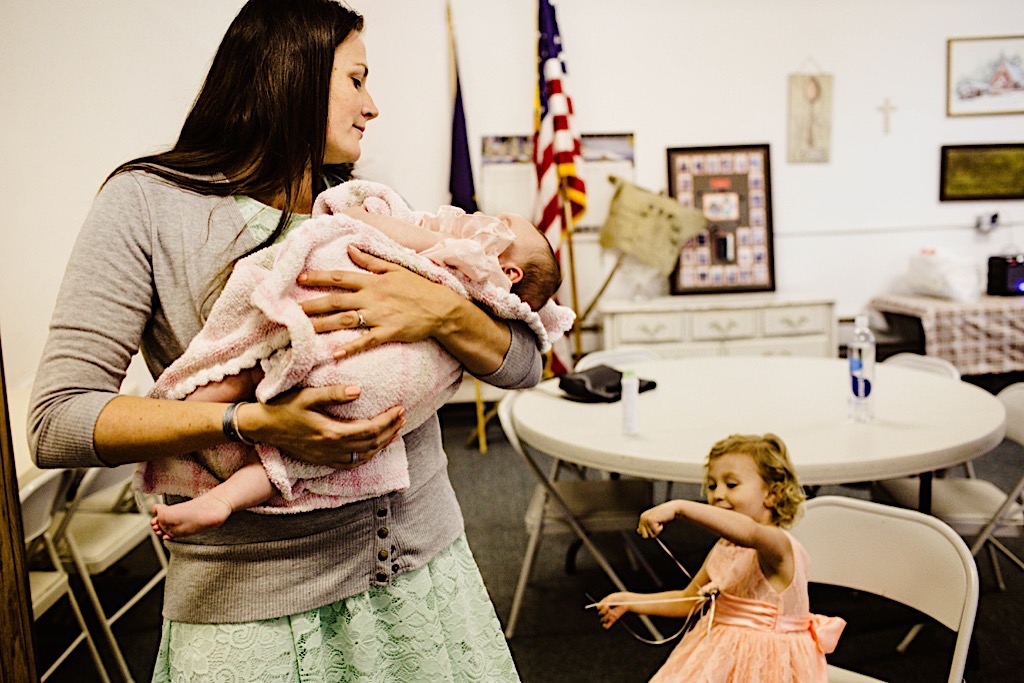 woman holding baby in church basement 
