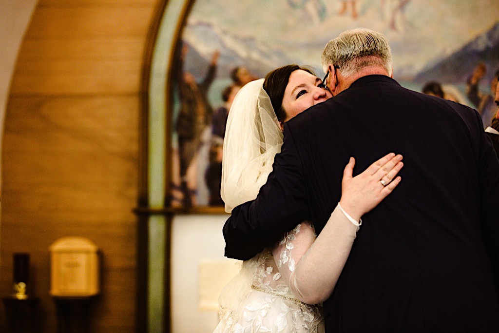bride hugging father at st. peter's episcopal church