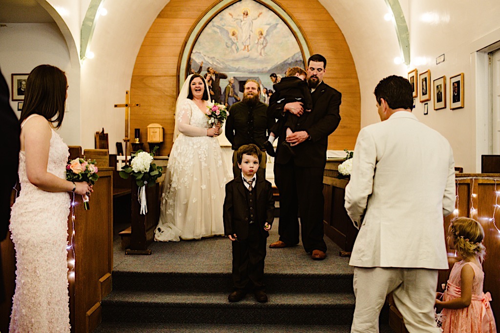 ring bearer standing in middle of ceremony st. peter's episcopal church