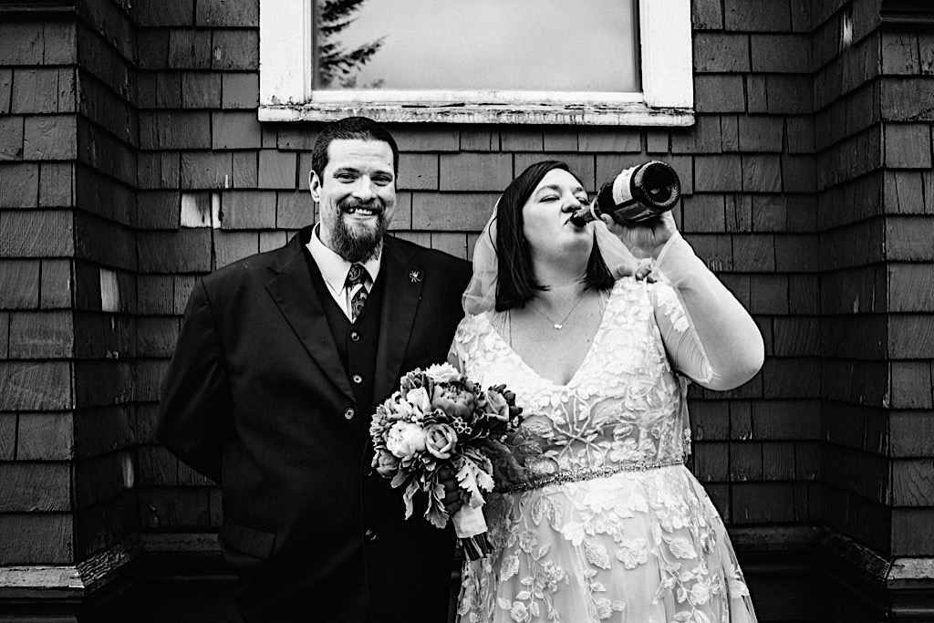 bride drinking champagne from the bottle 