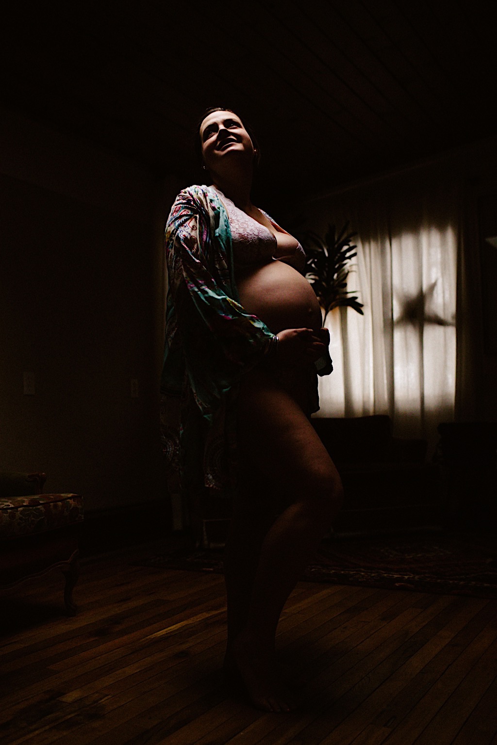dark and moody shot of pregnant woman 