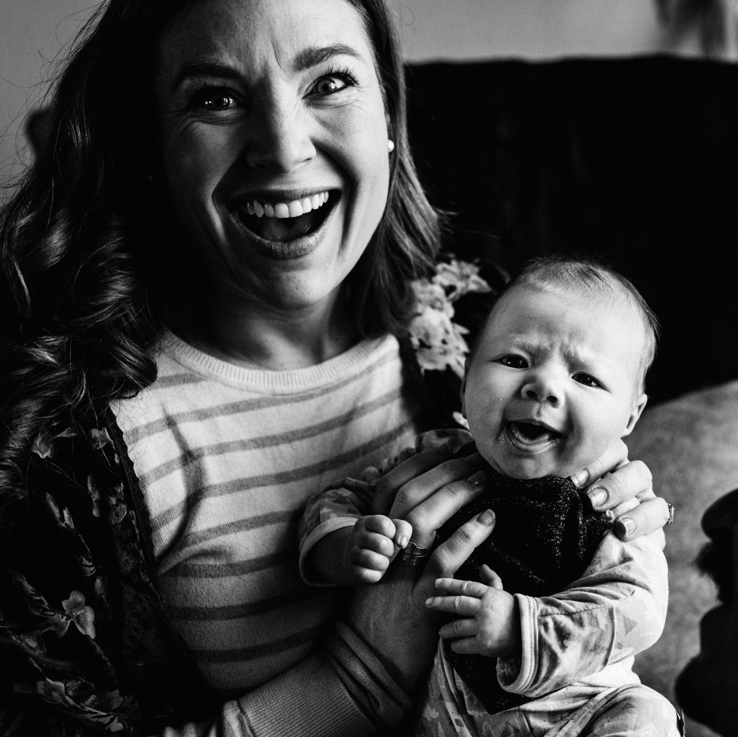 mom laughing while baby makes funny face