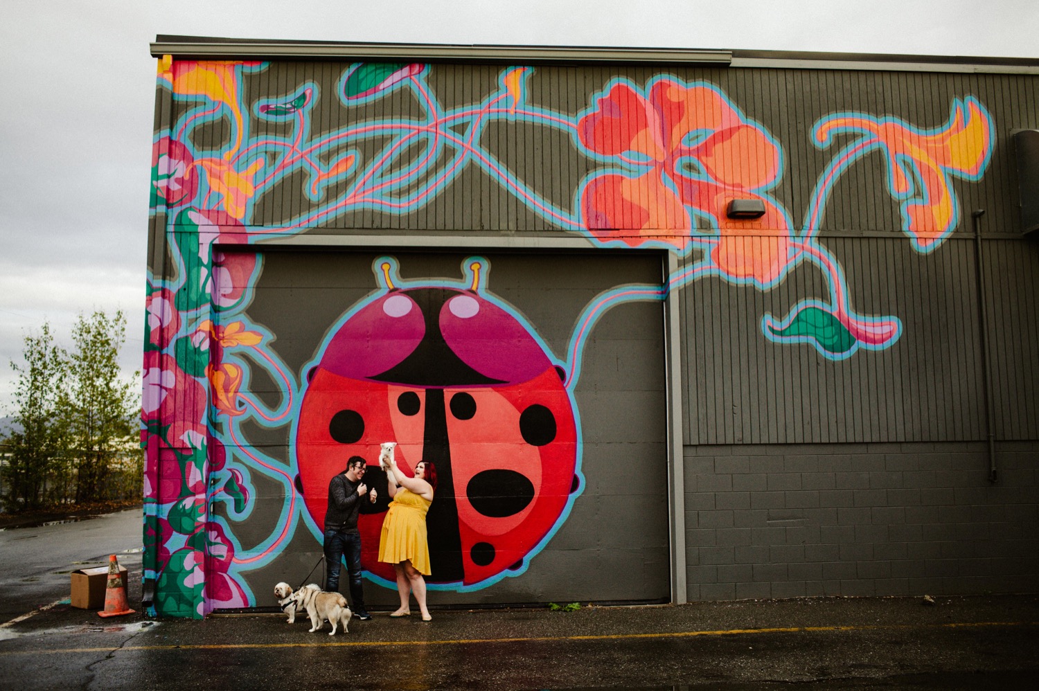couple in front of ladybug mural