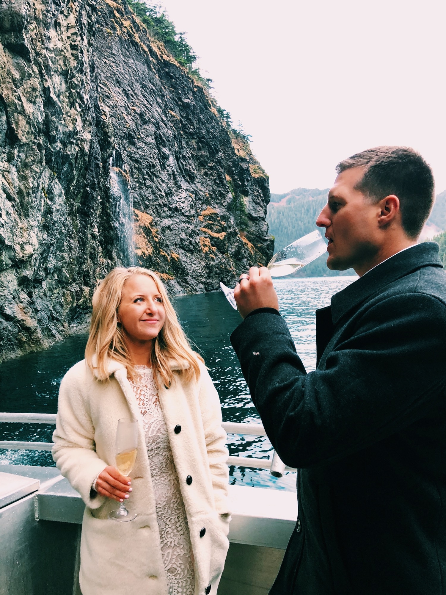 bride and groom share champagne toast during adventure elopement video seward alaska