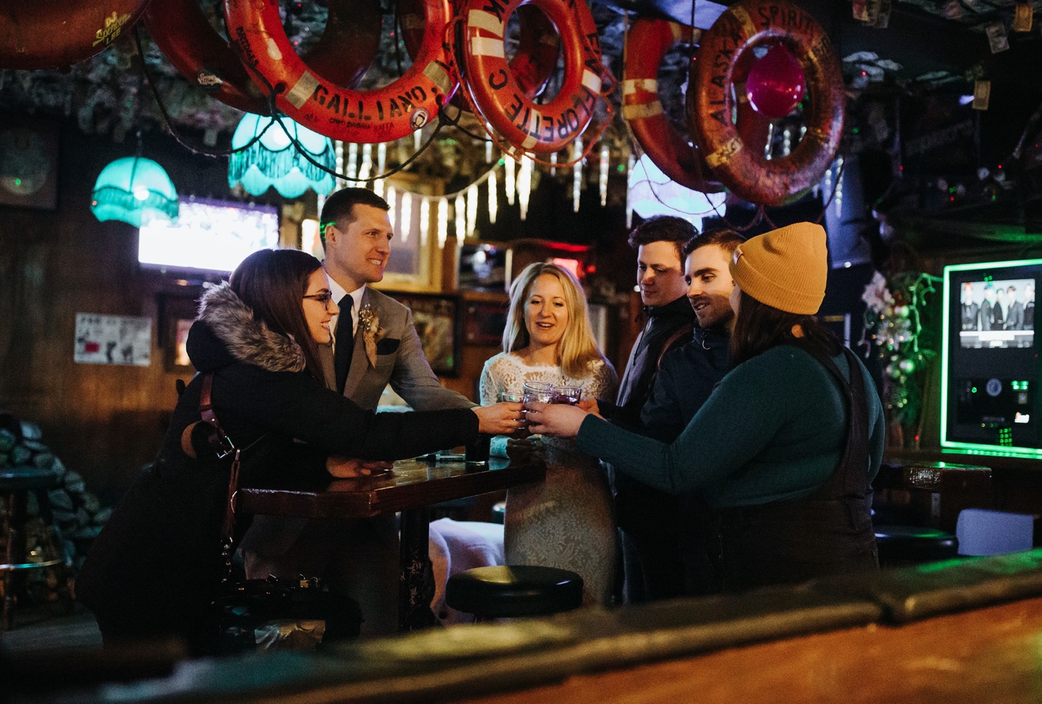 bride and groom share a toast with wedding vendors at yukon bar