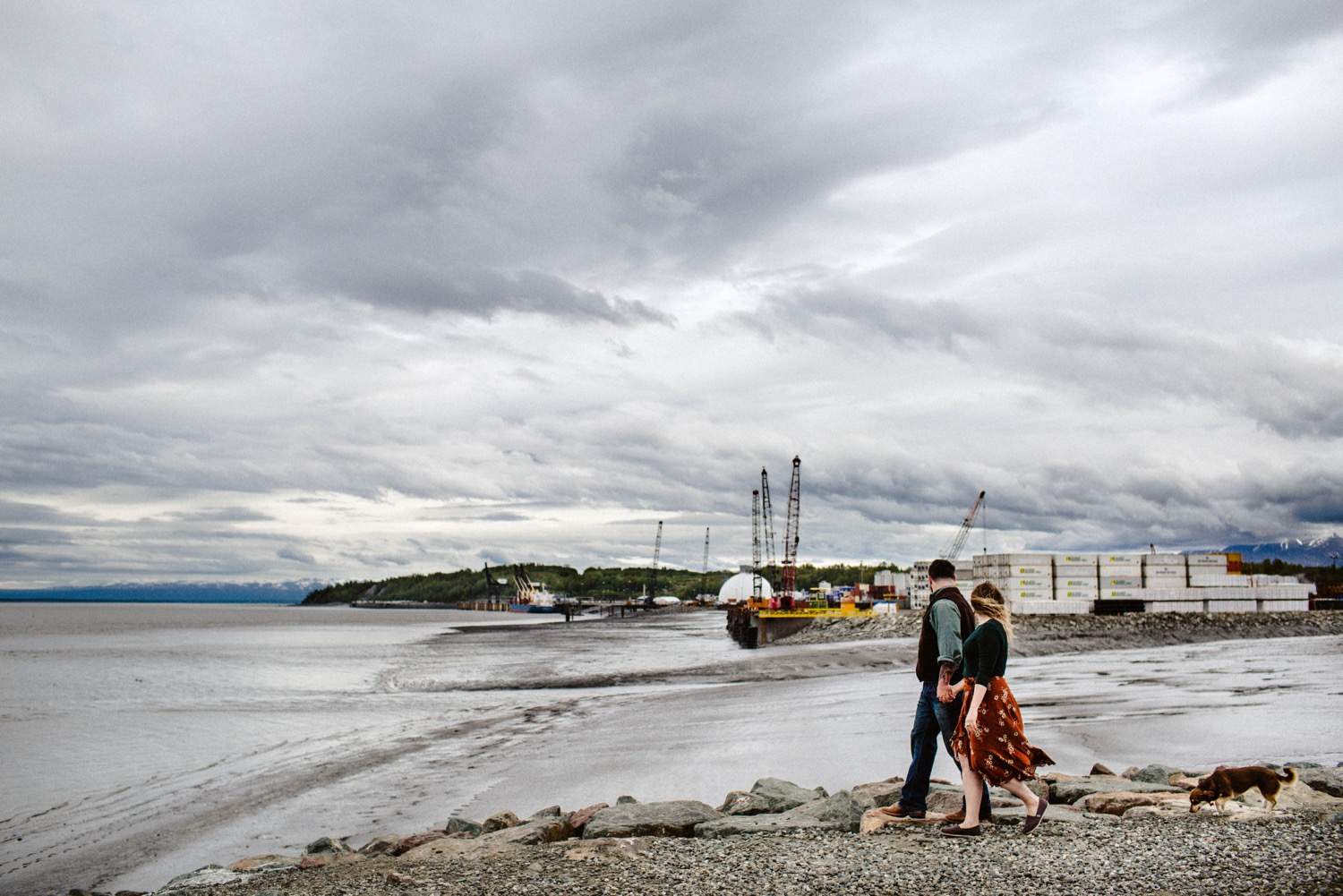 couple walking hand in hand at port of anchorage