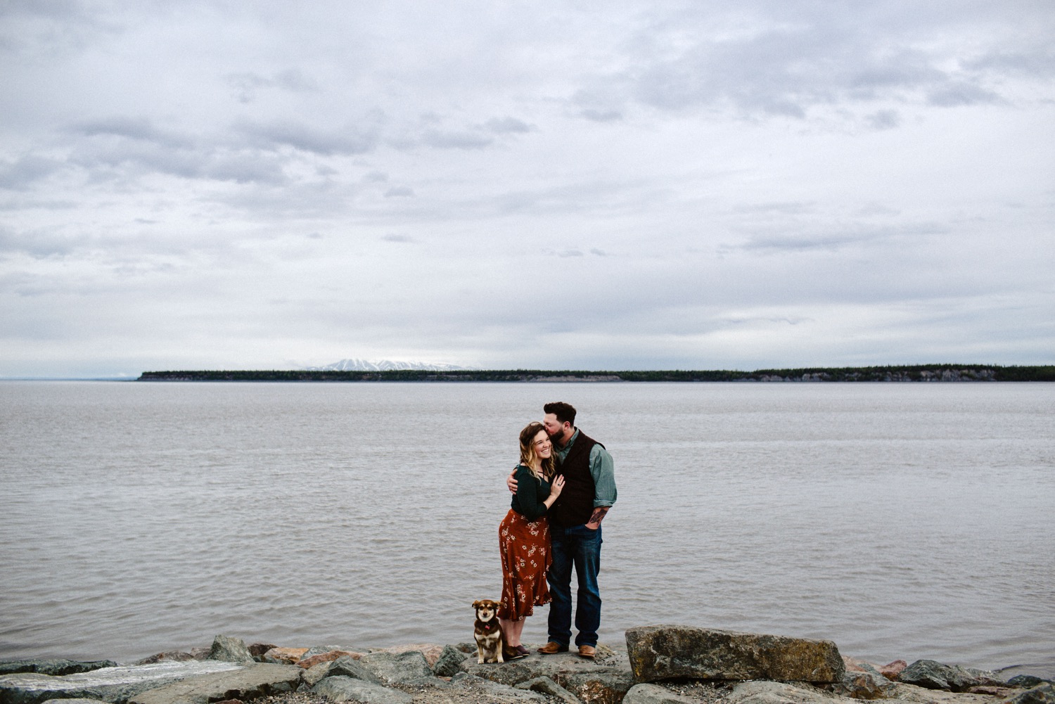 anchorage couple kissing with wide view of cook inlet 