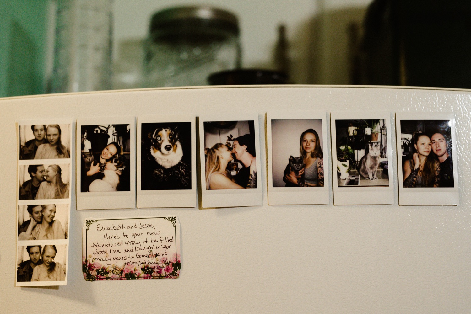polaroids of bride and groom hung up on refrigerator
