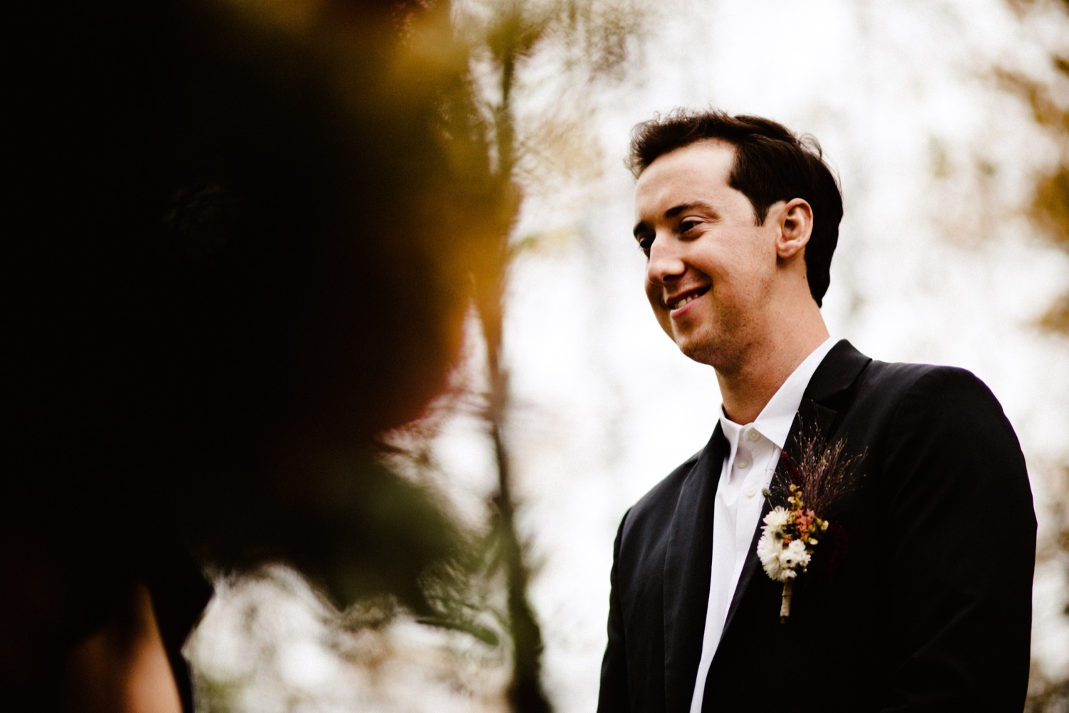 alaska groom smiles at bride