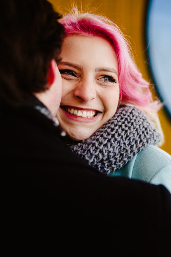 girl with pink hair smiling