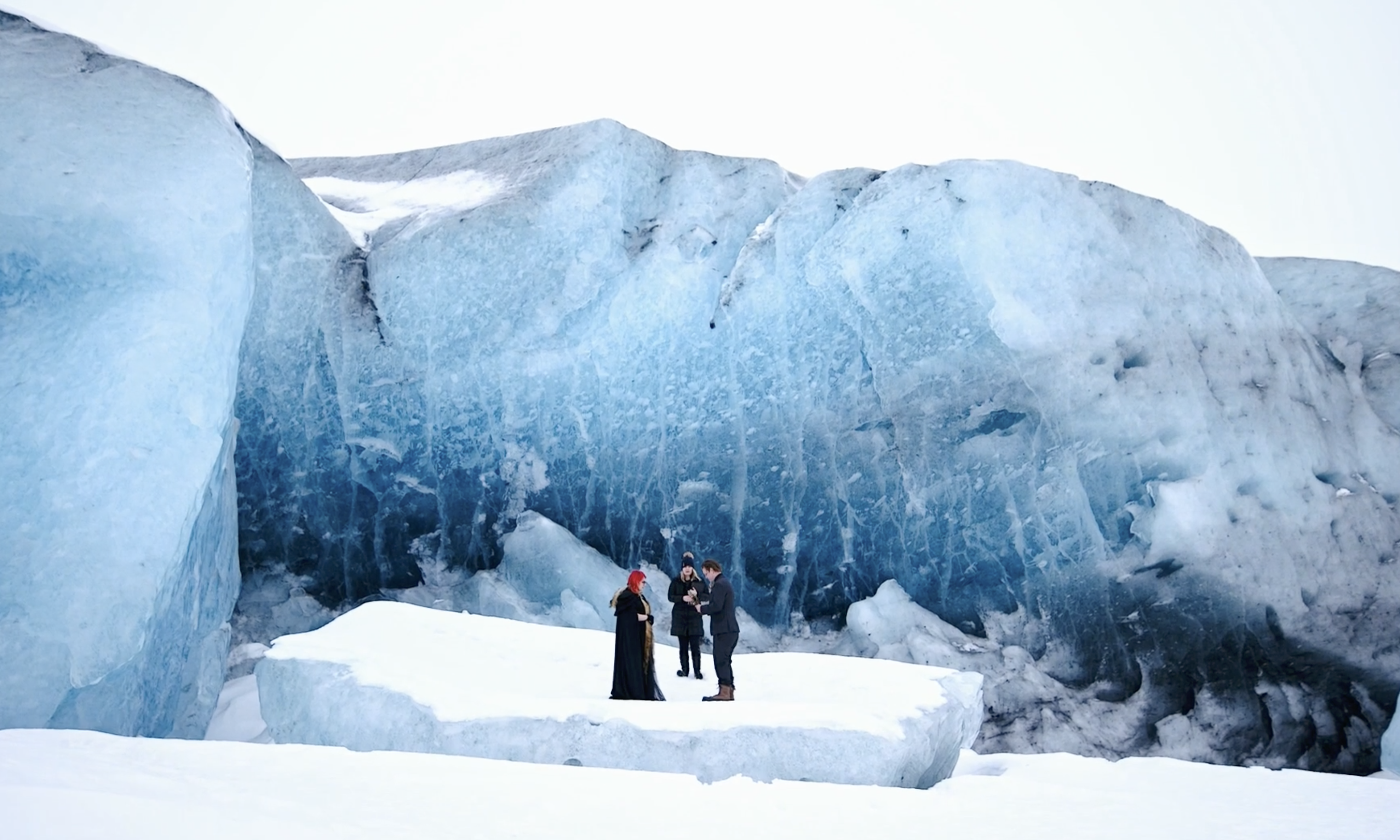 wedding couple says vows in front of ice wall in alaska