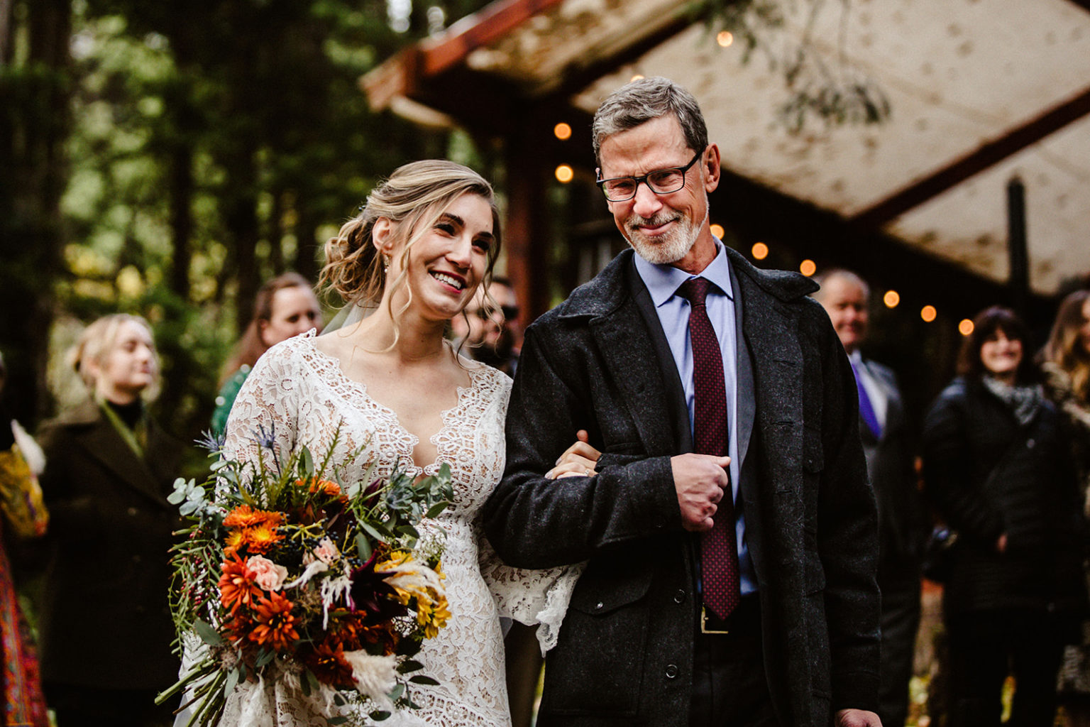bride and father walk down aisle during raven glacier lodge wedding ceremony