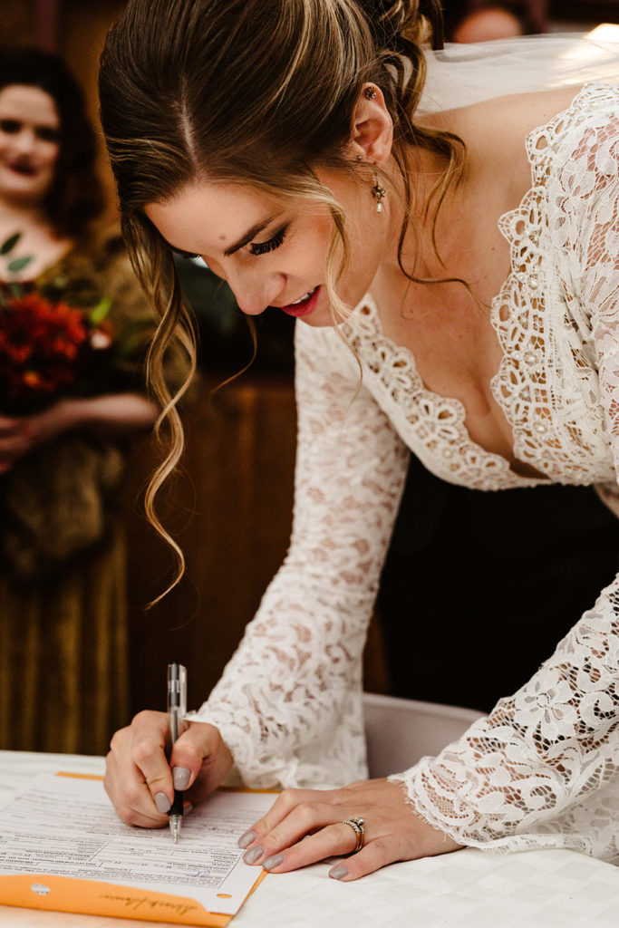 bride signs marriage certificate
