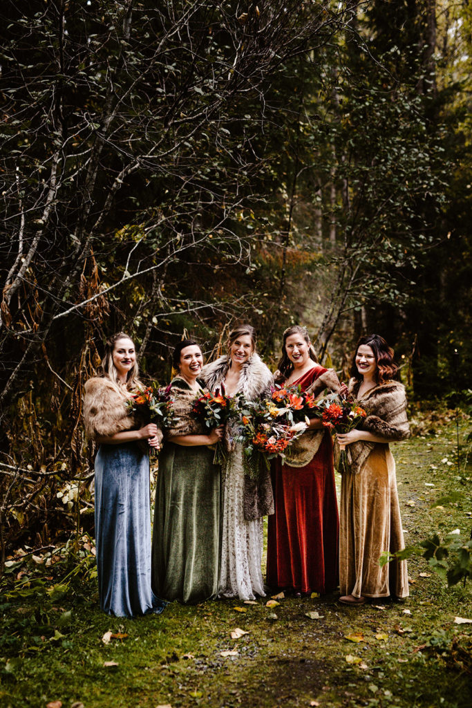 bridesmaids in jewel toned velvet dresses at raven glacier lodge