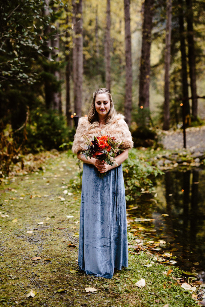 bridesmaid in fur holding fall floral bouquet