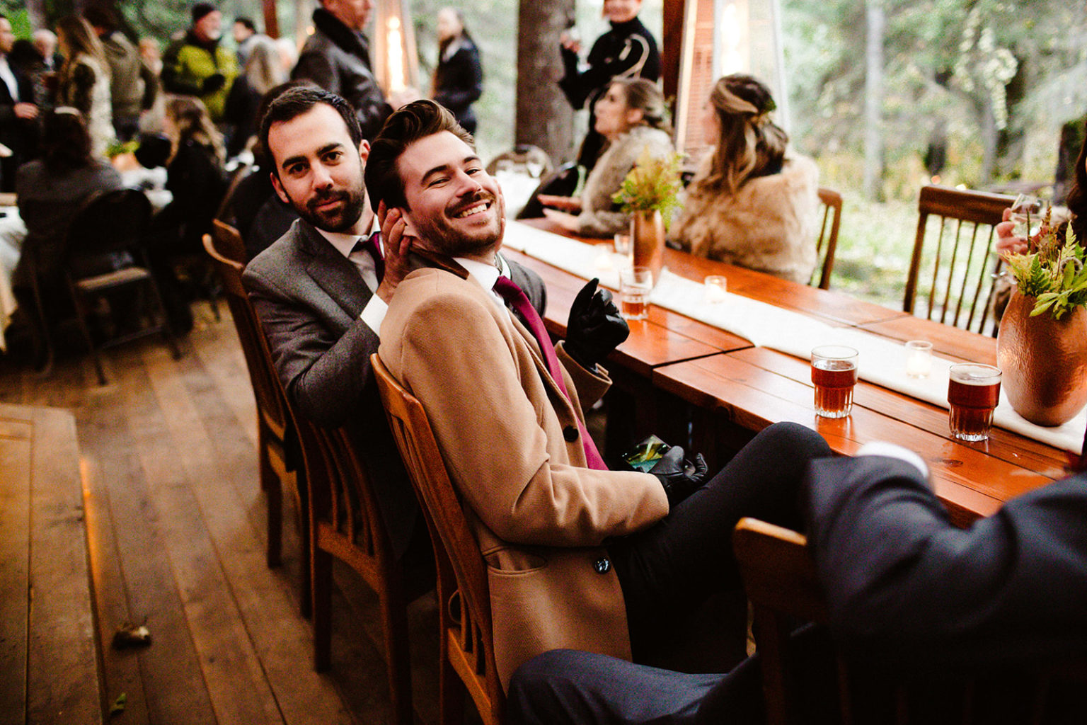 groomsmen smile at wedding reception