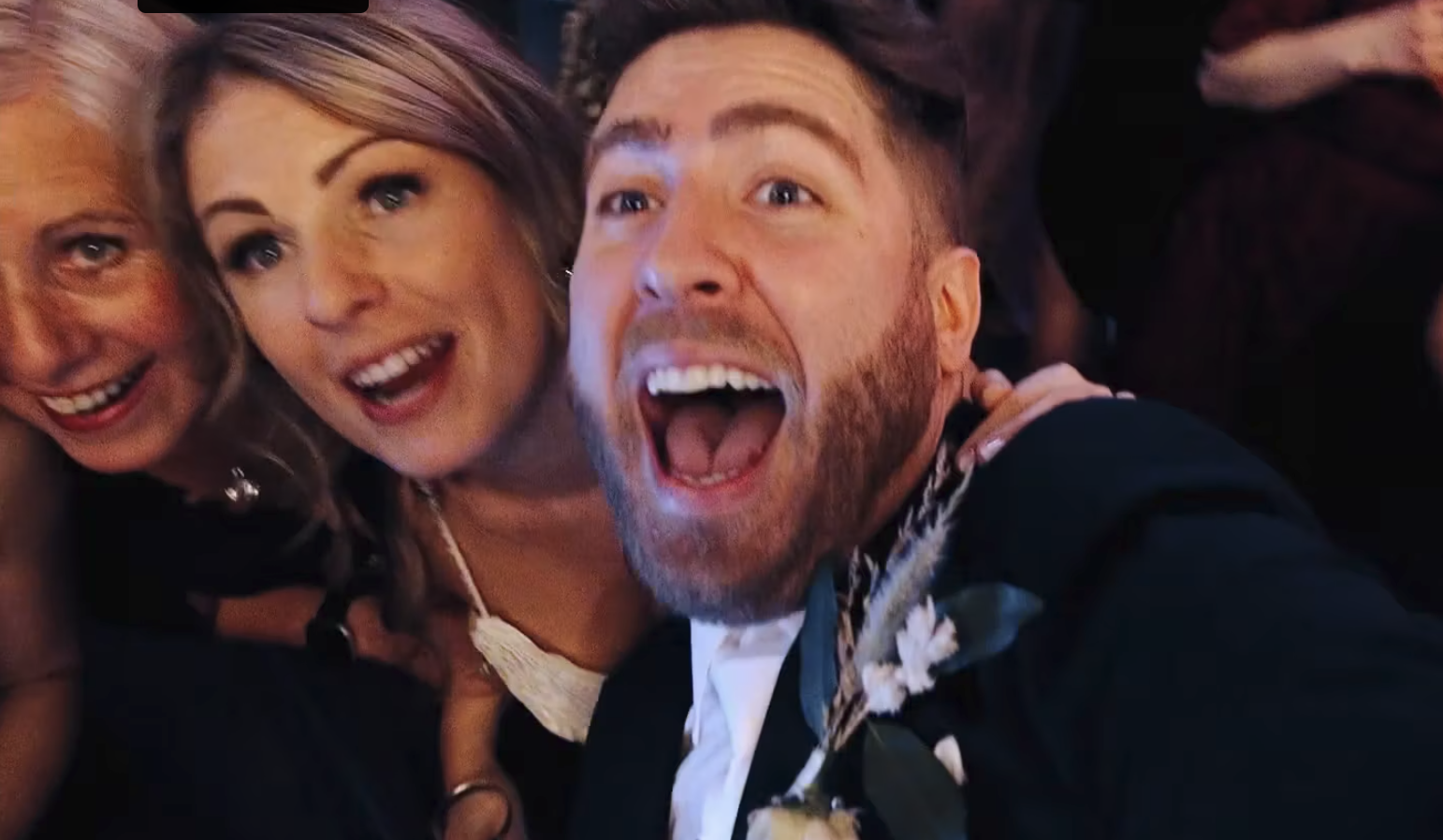 bride and groom take selfie with camera